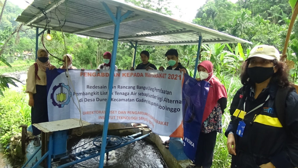 Dr. Dra Melania Suweni Muntini MT (left) with ITS Physics Department students when surveying the condition of micro-hydro equipment in Duren Village, Probolinggo