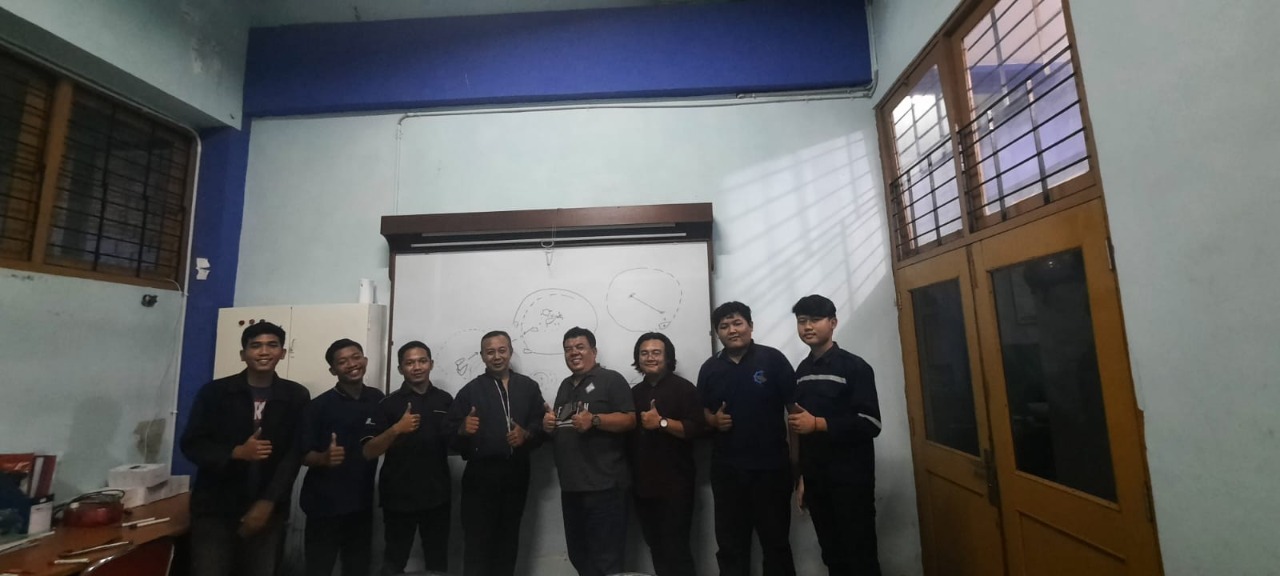 Naufal Shafiy Angkasa Putra (right) with the Baito Deling team while at the ITS Ship Production Management and Technology Laboratory