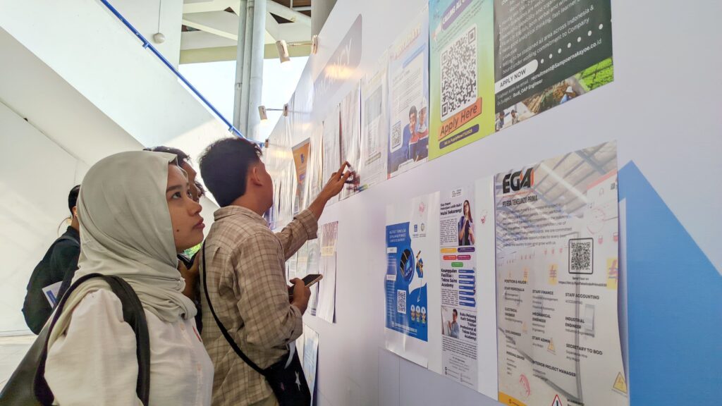 Gambar Mahasiswa Departemen Manajemen Bisnis ITS Malva Aliya Izza Bachtiar mengamati jajaran poster lowongan kerja berbagai perusahaan