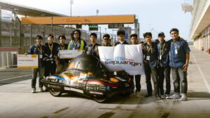 Team Sapuangin ITS with their Urban Concept vehicle at the track area of the Shell Eco-marathon Asia Pacific and the Middle East 2026 in Qatar.