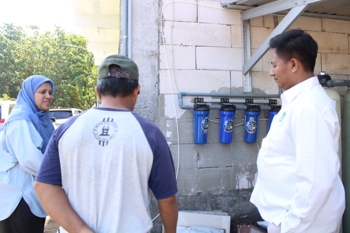 Tim PMKI 2026 saat meninjau alat penyaringan air berbasis reverse osmosis (RO) di Desa Tambak Kalisogo, Sidoarjo