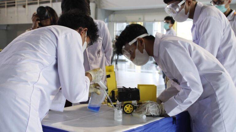 Student team mixing chemical reaction fuel for their prototype car before the ICRCC 2026 race heat.