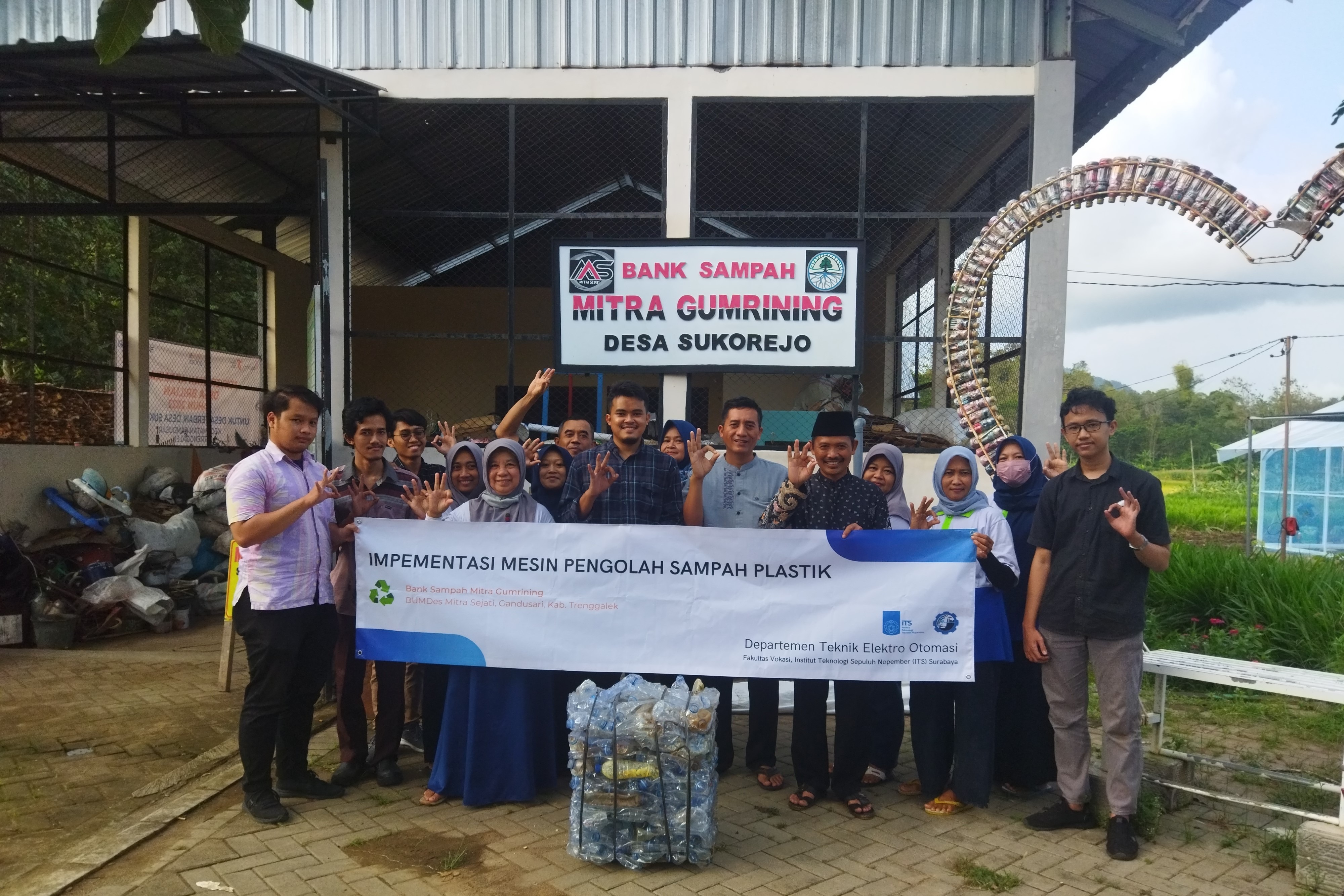 Head of the Vocational Faculty Abmas DTEO team, Dwiky Fajri Syahbana ST M.T taking a photo with the team  in front of the Abmas location, Mitra Grumining Garbage Bank
